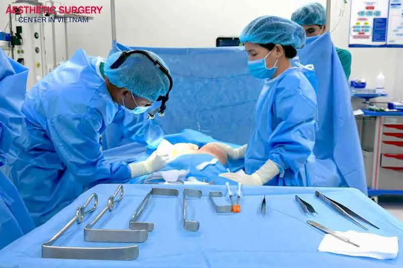 The doctor proceeds to insert the breast implant into the chest pocket