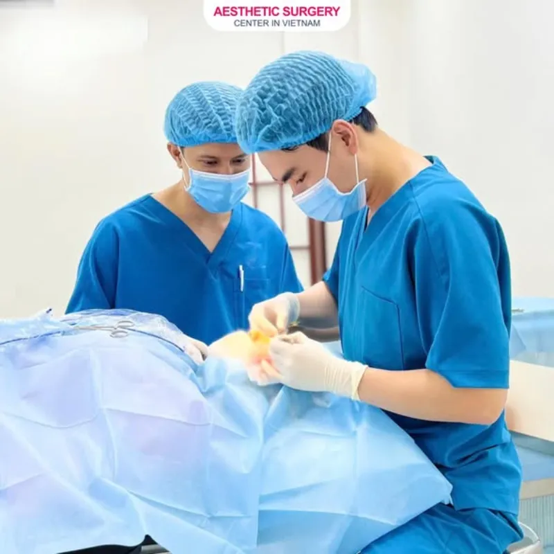 The surgeon performs rhinoplasty for the patient.