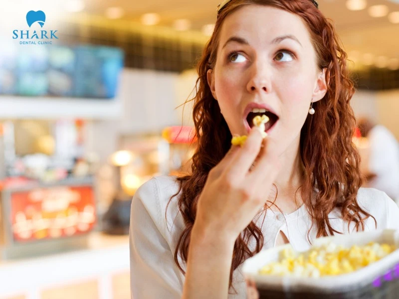 You should not eat popcorn while wearing braces because it can get stuck in the brackets, affecting the effectiveness of orthodontic treatment