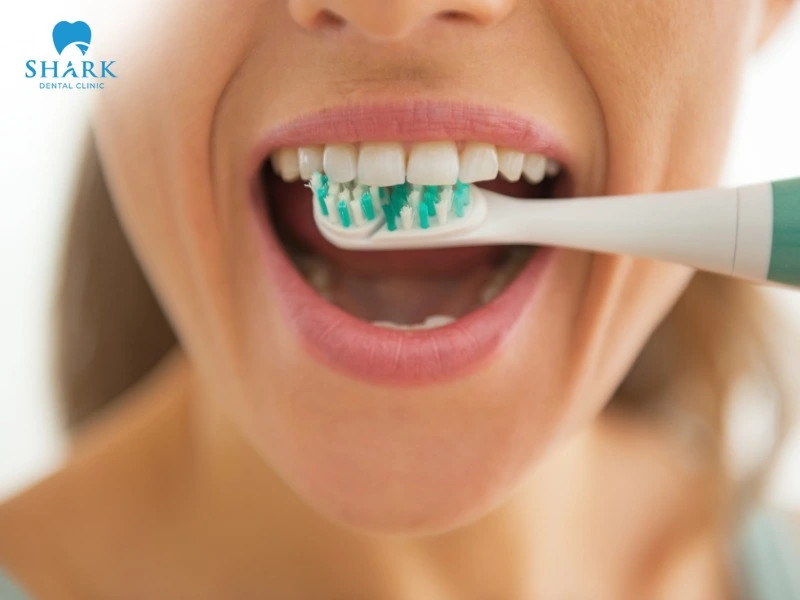 You can use an electric toothbrush or an interdental brush to clean your teeth daily