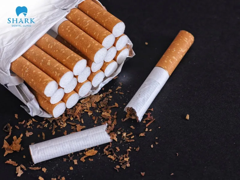 Cigarettes contain nicotine, which causes plaque buildup on the surface of the teeth
