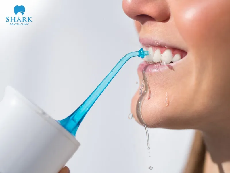 Using a water flosser helps clean between teeth while massaging the gums and tooth roots, reducing the risk of infection