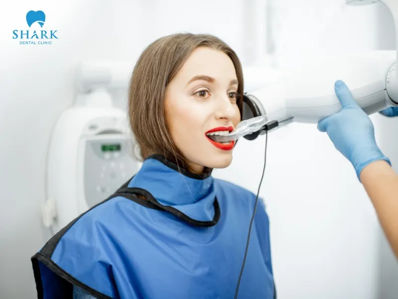 The dentist needs to examine the surrounding tissues to assess the extent of damage after taking an X-ray