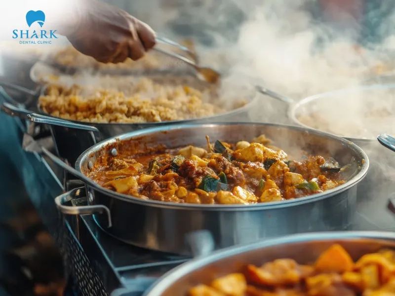 After a dental filling, you should avoid foods that are too hot or heavily seasoned