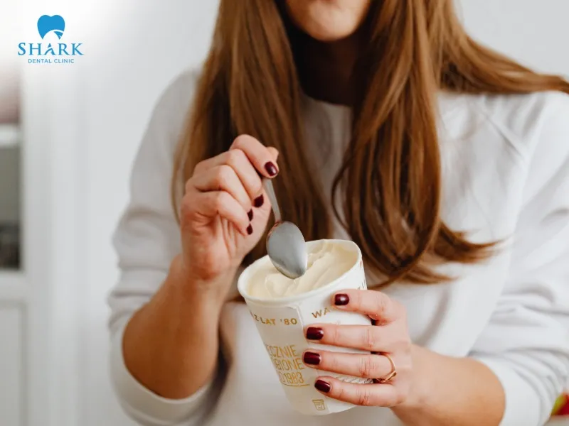 You should wait until the ice cream softens and is less cold, then use a spoon to eat itYou should wait until the ice cream softens and is less cold, then use a spoon to eat it