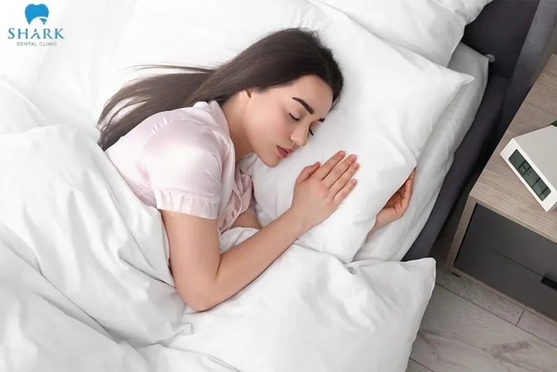 Lying on the side of the healthy jaw is a commonly recommended position when considering how to sleep after tooth extraction