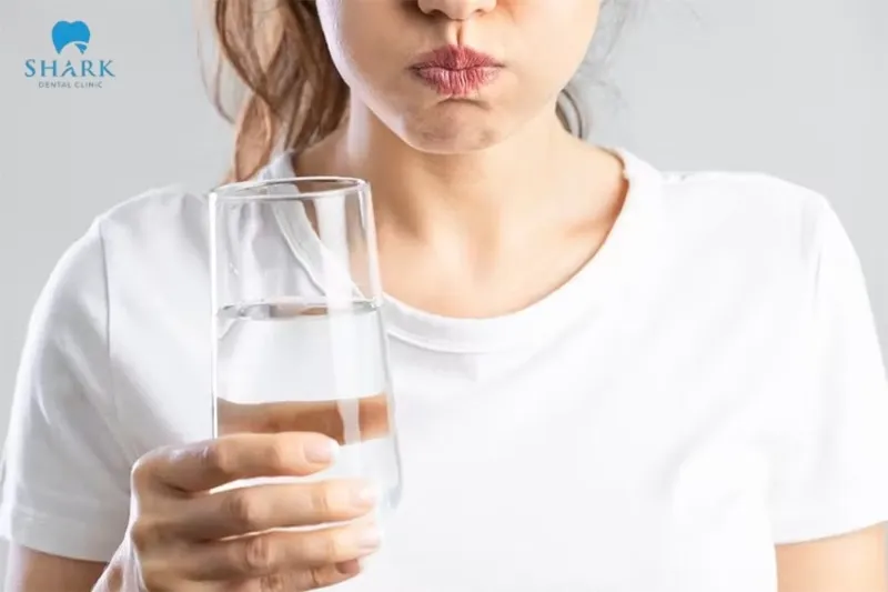 Rinsing with warm salt water 24 hours after extraction helps disinfect the area and effectively soothe the gums