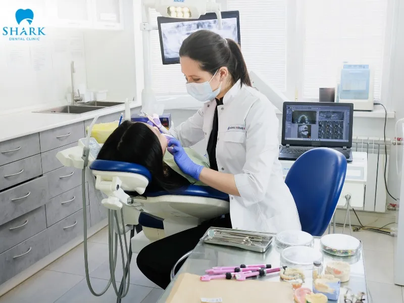 The dentist attaches the removable overdenture onto the implants through a specialized attachment and locking system