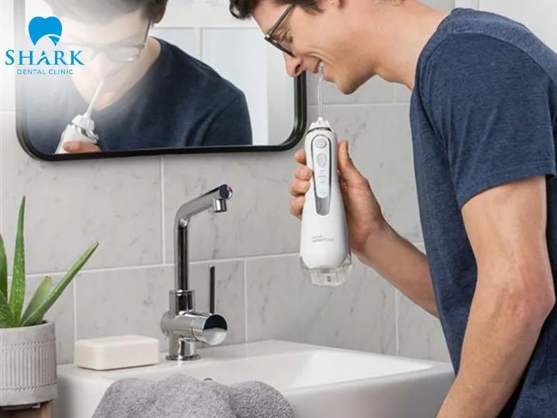 A water flosser helps protect the gum line and maintain the long-term effectiveness of porcelain veneer restoration