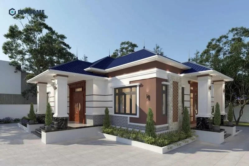 Mẫu nhà chữ L mái ngói Nhật xanh 1 tầng được thiết kế với hệ thống cây bao quanh