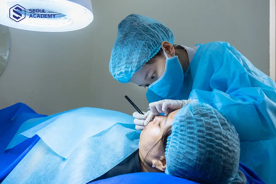 Kỹ thuật viên đeo bao tay và đồ bảo hộ khi phun xăm