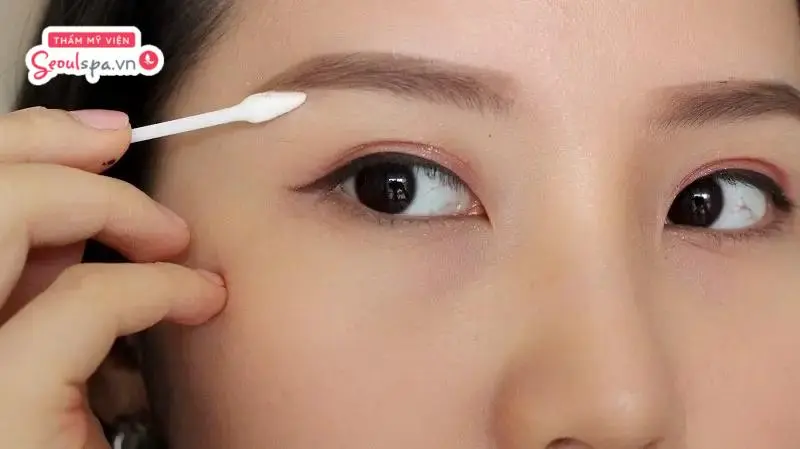 Sử dụng tăm bông thoa thuốc mỡ chân mày để đảm bảo vệ sinh và kiểm soát tốt liều lượng thuốc bôi trên da